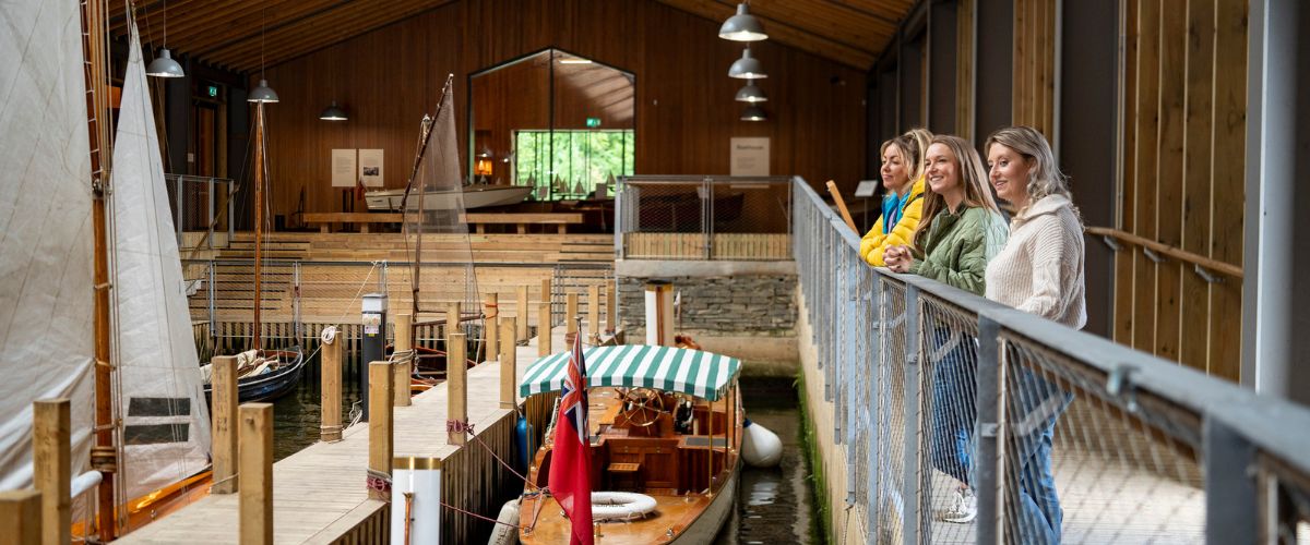Visitors look at the boats on display at Windermere Jetty Museum